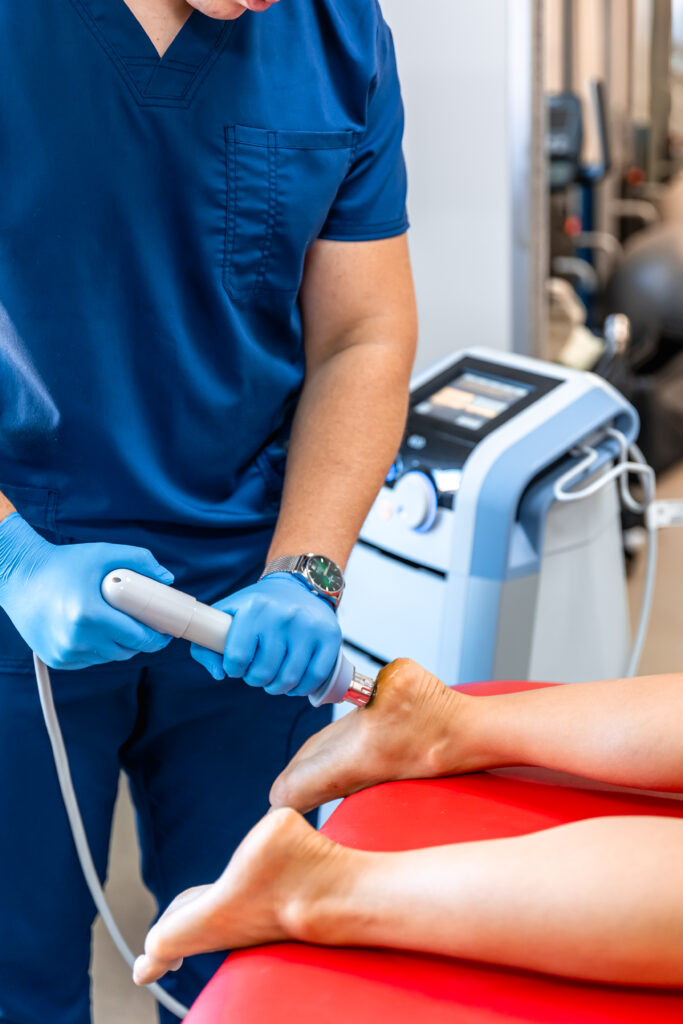 Patient getting non-surgical treatment with shock waves for plantar fasciitis.